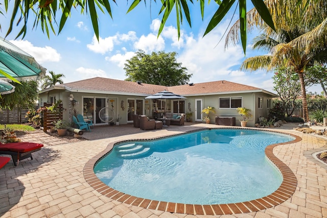 view of swimming pool with an outdoor living space, a patio, and fence
