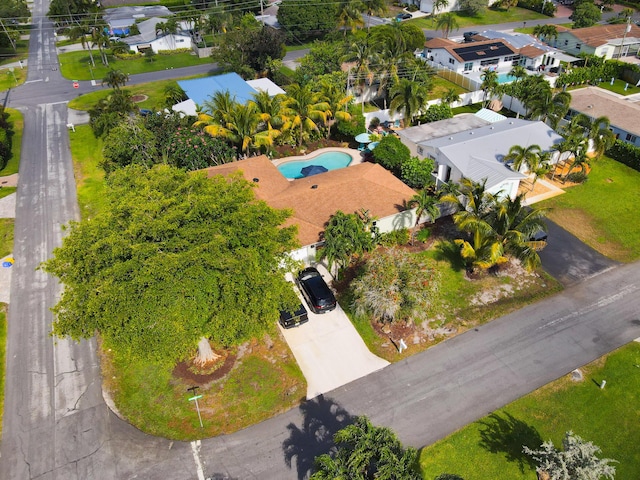 view of property location with a pool area and nearby suburban area
