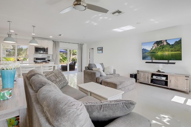 living room featuring a ceiling fan, light tile patterned floors, and recessed lighting