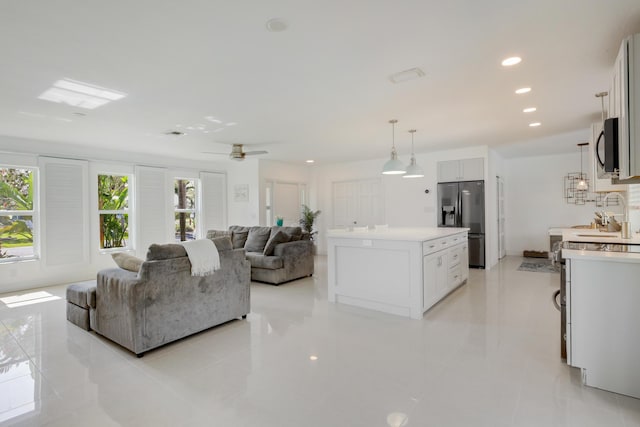 living area with light tile patterned floors, recessed lighting, and ceiling fan