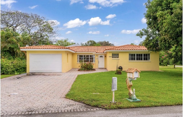 1401 Shore Dr, Lake Clarke Shores, FL 33406 - view of front facade featuring a garage, stucco siding, decorative driveway, and a front lawn