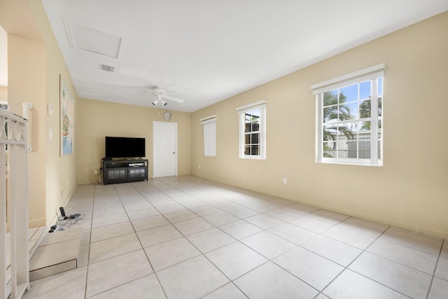 1401 Shore Dr, Lake Clarke Shores, FL 33406 - unfurnished living room with light tile patterned flooring, attic access, a ceiling fan, and baseboards