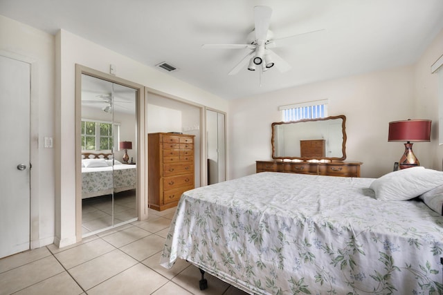 1401 Shore Dr, Lake Clarke Shores, FL 33406 - bedroom with two closets, light tile patterned floors, and a ceiling fan