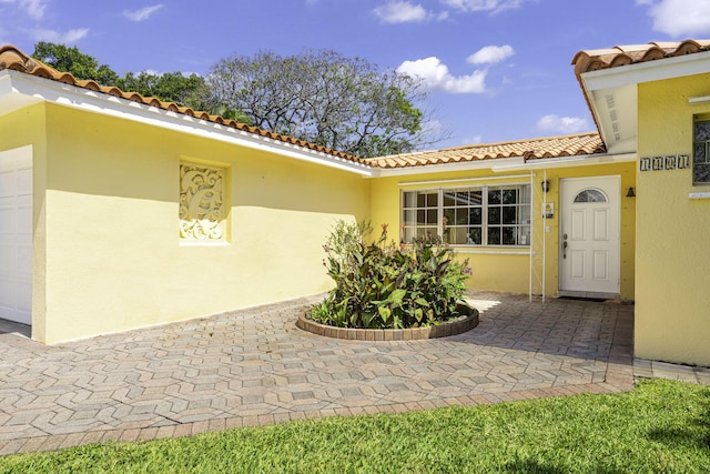 1401 Shore Dr, Lake Clarke Shores, FL 33406 - entrance to property featuring a tiled roof and stucco siding