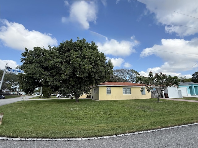 1401 Shore Dr, Lake Clarke Shores, FL 33406 - view of side of property featuring a lawn and stucco siding