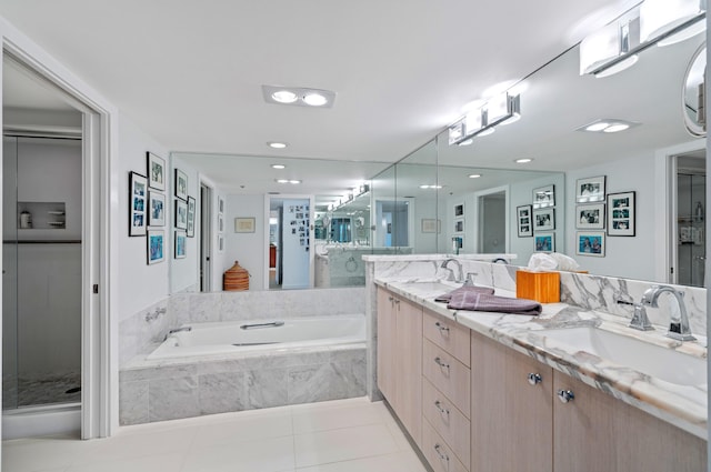 901 E Camino Real Unit 4C, Boca Raton, FL 33432 - full bathroom with double vanity, a bath, tile patterned flooring, a shower stall, and recessed lighting