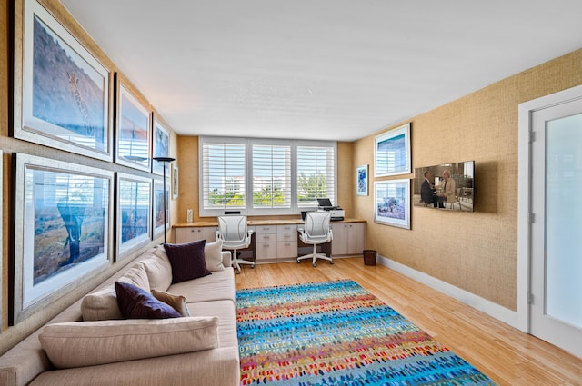901 E Camino Real Unit 4C, Boca Raton, FL 33432 - living room with light wood-style flooring, healthy amount of natural light, baseboards, an office area, and wallpapered walls