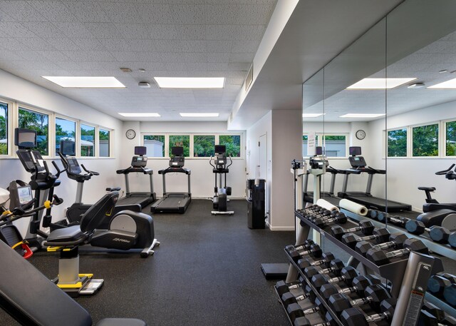 901 E Camino Real Unit 4C, Boca Raton, FL 33432 - workout area featuring plenty of natural light, a paneled ceiling, and baseboards