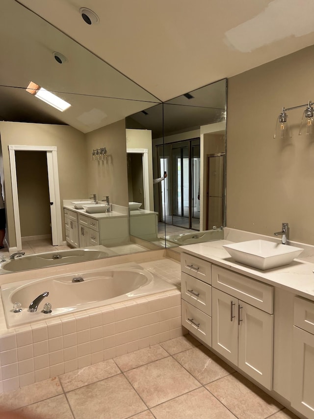 full bathroom featuring vanity, a bath, and tile patterned floors