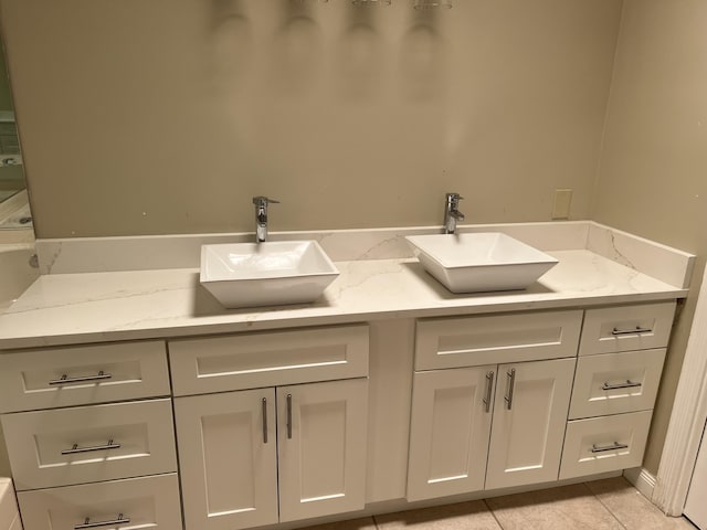 bathroom with double vanity and tile patterned floors