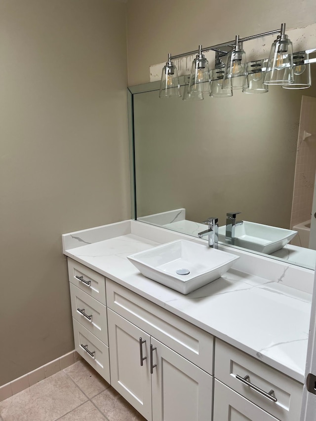 bathroom featuring vanity, tile patterned floors, and baseboards