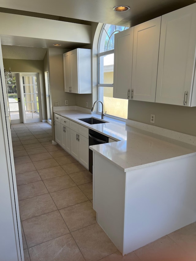 kitchen featuring a sink, white cabinetry, light tile patterned flooring, light countertops, and recessed lighting