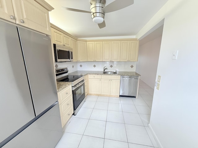 1036 Hythe B B, Boca Raton, FL 33434 - kitchen featuring appliances with stainless steel finishes, light stone countertops, a ceiling fan, and light tile patterned floors