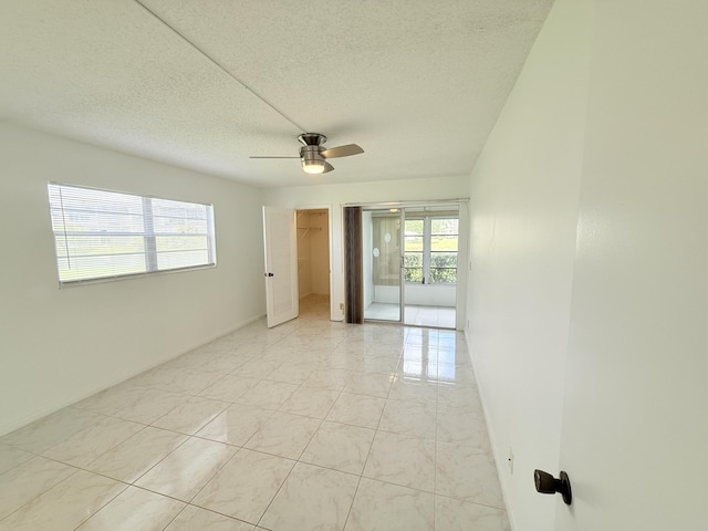 1036 Hythe B B, Boca Raton, FL 33434 - empty room with ceiling fan and a textured ceiling