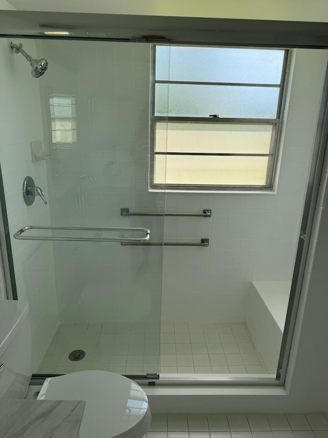 bathroom with toilet and a stall shower