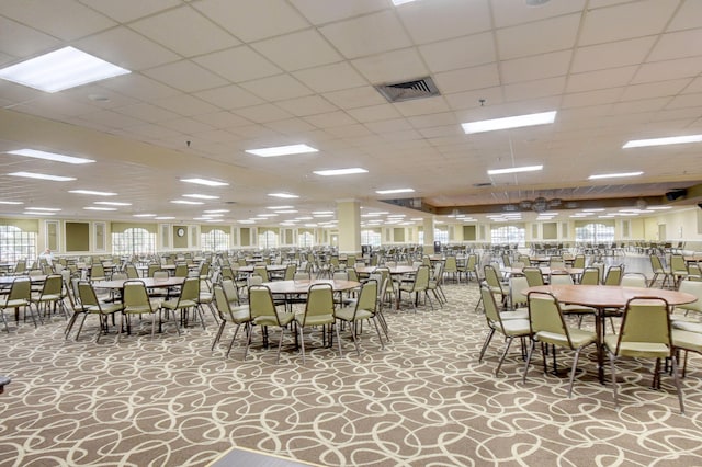 dining space featuring a paneled ceiling and carpet flooring