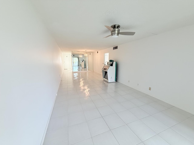 1036 Hythe B B, Boca Raton, FL 33434 - unfurnished room with heating unit, ceiling fan, and light tile patterned floors