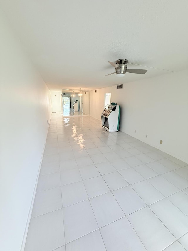 1036 Hythe B B, Boca Raton, FL 33434 - empty room featuring heating unit, ceiling fan, and light tile patterned flooring