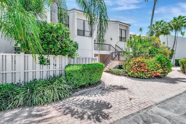 903 Bridgewood Pl, Boca Raton, FL 33434 - view of front facade with stairs, fence, and stucco siding