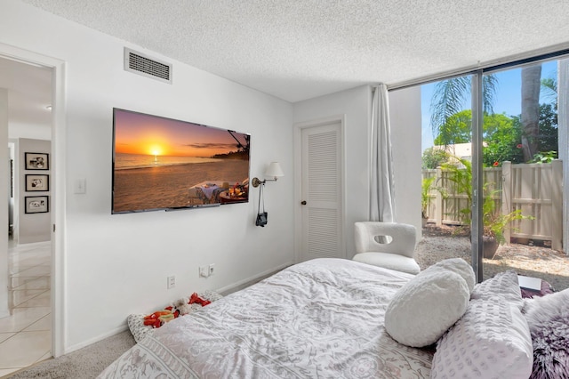 903 Bridgewood Pl, Boca Raton, FL 33434 - bedroom featuring access to exterior, a textured ceiling, and baseboards