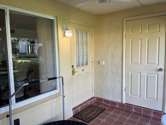 311 Pine Ridge Cir Unit B-1, Greenacres, FL 33463 - doorway to property featuring ceiling fan and stucco siding