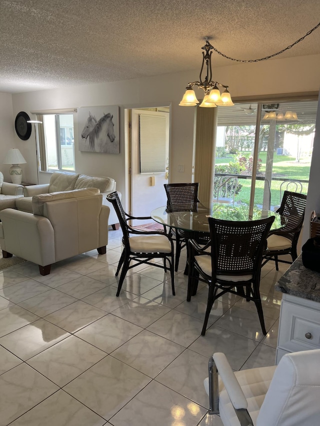 311 Pine Ridge Cir Unit B-1, Greenacres, FL 33463 - dining space featuring a chandelier, light tile patterned floors, and a textured ceiling