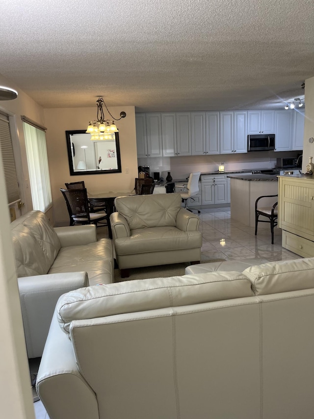 311 Pine Ridge Cir Unit B-1, Greenacres, FL 33463 - living area featuring a chandelier and a textured ceiling