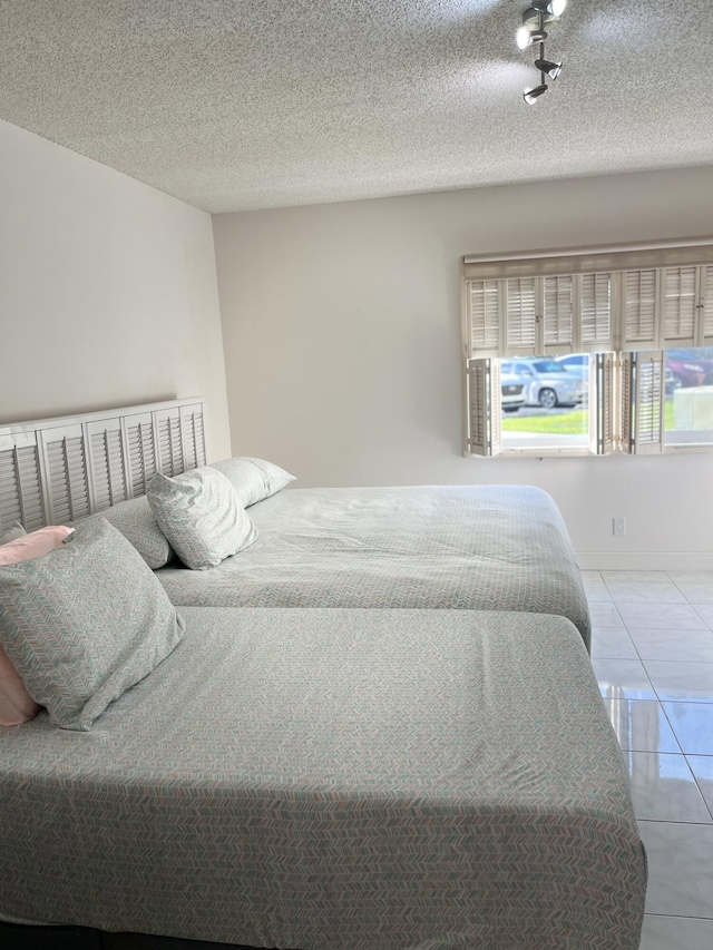 311 Pine Ridge Cir Unit B-1, Greenacres, FL 33463 - bedroom with tile patterned flooring and a textured ceiling