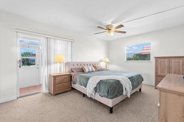 266 Seville L, Delray Beach, FL 33446 - bedroom featuring multiple windows, light carpet, access to exterior, and baseboards
