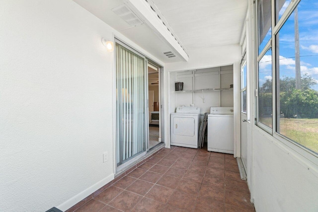 266 Seville L, Delray Beach, FL 33446 - unfurnished sunroom featuring washer and dryer and healthy amount of natural light