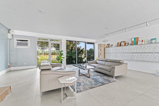 5500 NW 2nd Ave Unit 414, Boca Raton, FL 33487 - living room with a wall mounted air conditioner, rail lighting, mail area, and baseboards
