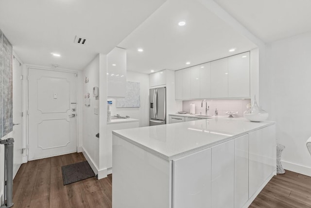 5500 NW 2nd Ave Unit 414, Boca Raton, FL 33487 - kitchen with stainless steel refrigerator with ice dispenser, modern cabinets, white cabinetry, dark wood-style floors, and recessed lighting