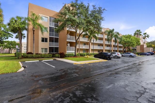 view of apartment building / complex with uncovered parking