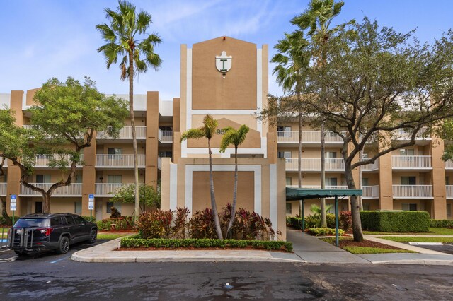 view of apartment building / complex with uncovered parking
