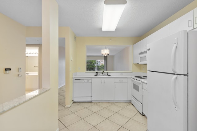 kitchen with light tile patterned floors, white appliances, light countertops, and a sink