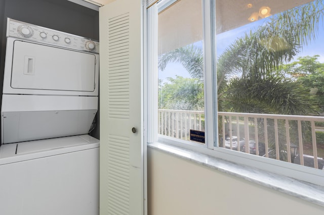 washroom with stacked washer / dryer and plenty of natural light