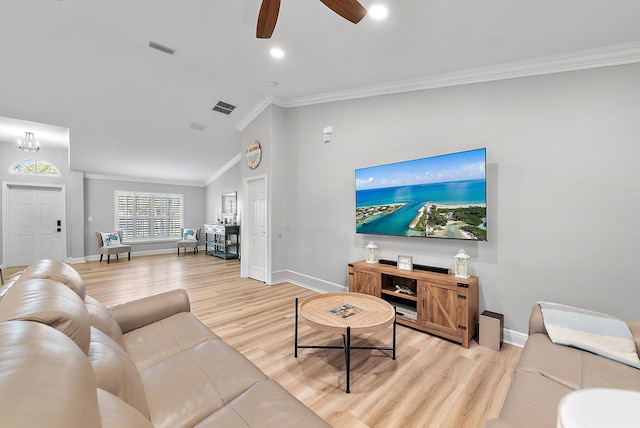 living room featuring crown molding, lofted ceiling, light wood-type flooring, baseboards, and ceiling fan