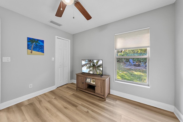 unfurnished room featuring a ceiling fan, light wood-style floors, and baseboards