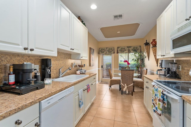 2149 SE Grand Dr, Port Saint Lucie, FL 34952 - kitchen featuring white appliances, a sink, backsplash, white cabinets, and light tile patterned floors
