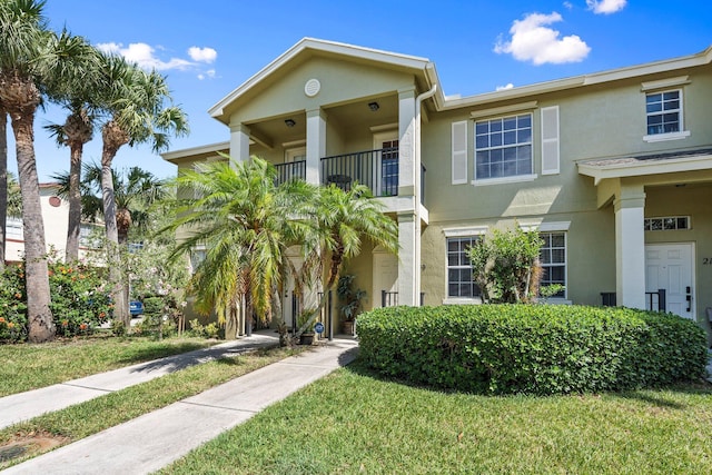 2149 SE Grand Dr, Port Saint Lucie, FL 34952 - multi unit property featuring stucco siding, a balcony, and a front yard
