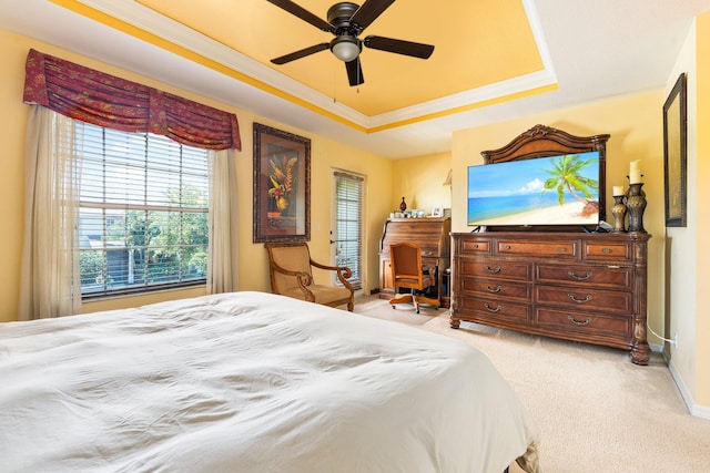 2149 SE Grand Dr, Port Saint Lucie, FL 34952 - bedroom featuring a tray ceiling, light carpet, multiple windows, ornamental molding, and baseboards