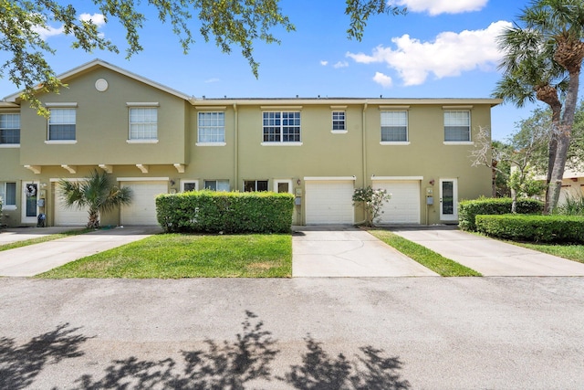 2149 SE Grand Dr, Port Saint Lucie, FL 34952 - view of property with stucco siding, driveway, and a garage