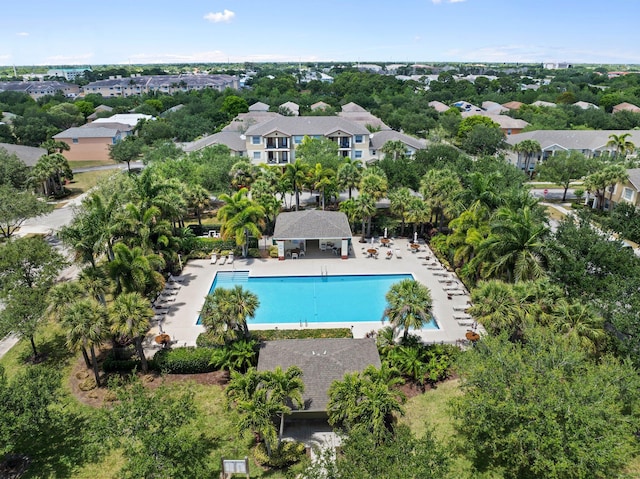2149 SE Grand Dr, Port Saint Lucie, FL 34952 - aerial perspective of suburban area with a pool area and a tree filled landscape