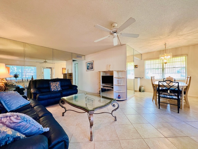 100 Sheffield E, West Palm Beach, FL 33417 - living room with a ceiling fan, a textured ceiling, a chandelier, plenty of natural light, and light tile patterned floors