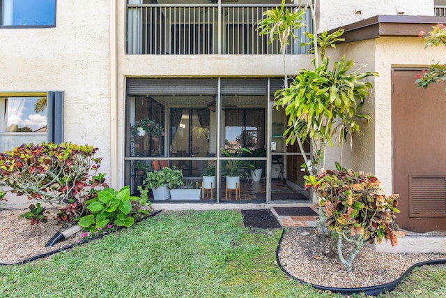 doorway to property featuring stucco siding