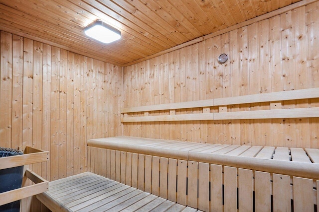 relaxing sauna / steam room featuring wooden walls and wooden ceiling