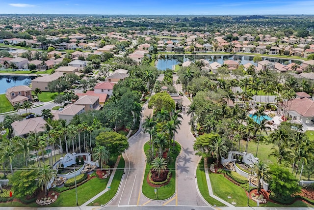 aerial view of property and surrounding area with nearby suburban area and a nearby body of water