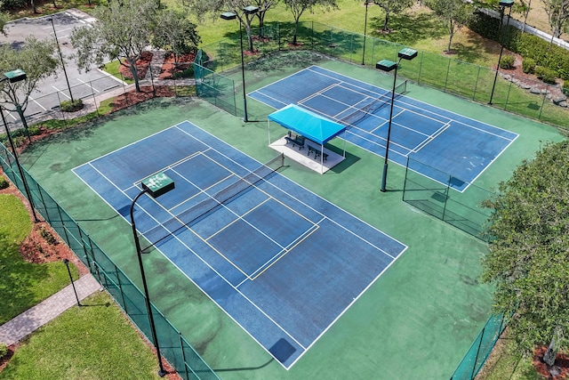view of tennis court featuring fence