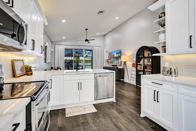 kitchen featuring stainless steel appliances, open shelves, a peninsula, a ceiling fan, and tasteful backsplash