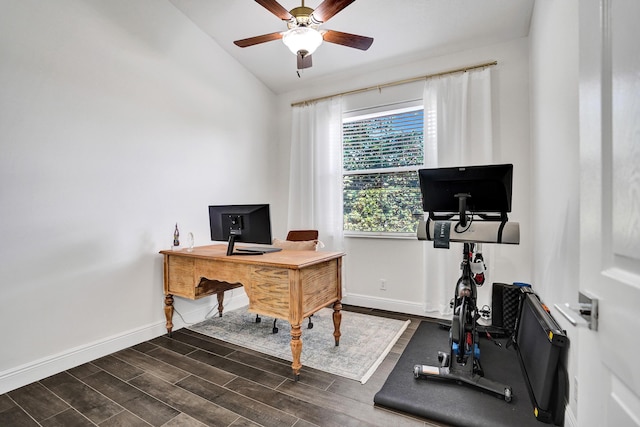 home office featuring lofted ceiling, a ceiling fan, baseboards, and wood finished floors